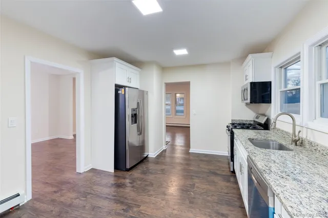 a kitchen with stainless steel appliances granite countertop a refrigerator stove and sink