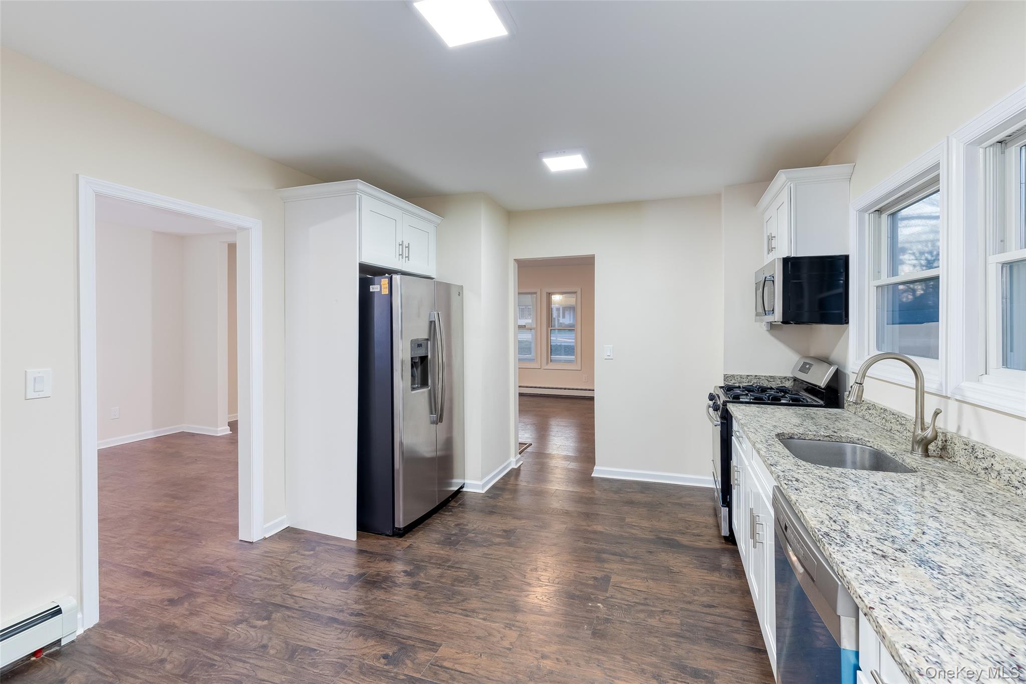 30170 Main Road Cutchogue, NY 11935 - Photo 4 of 9 a kitchen with stainless steel appliances granite countertop a refrigerator stove and sink