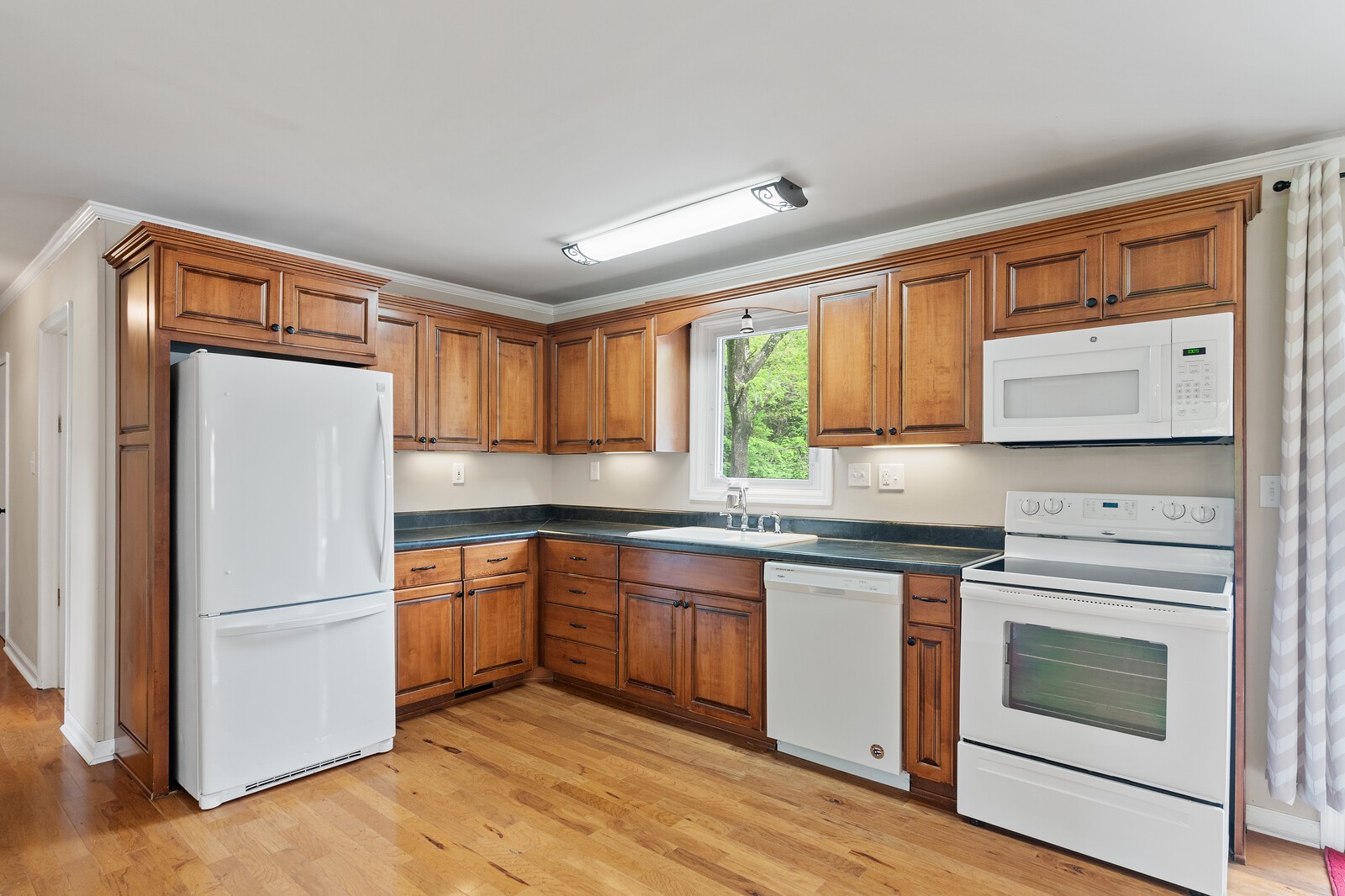 373 S Road Cottontown, TN 37048 - Photo 12 of 34 a kitchen with granite countertop appliances cabinets and a sink