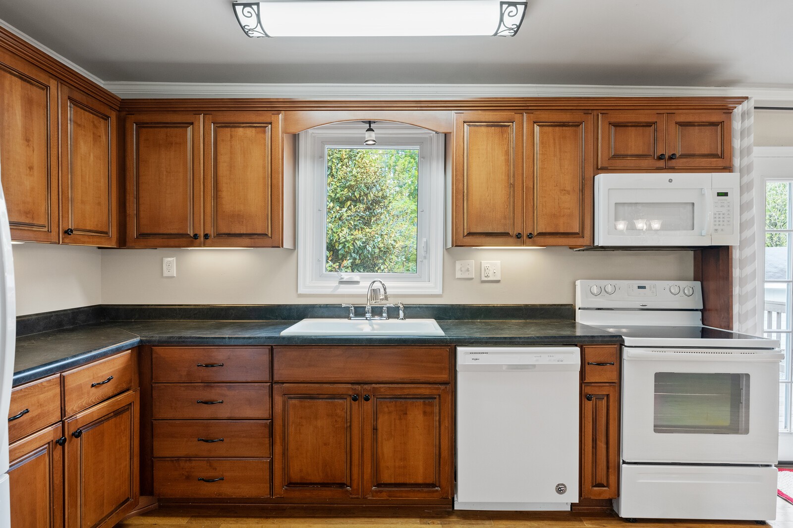 373 S Road Cottontown, TN 37048 - Photo 13 of 34 a kitchen with stainless steel appliances granite countertop a stove a sink and a microwave