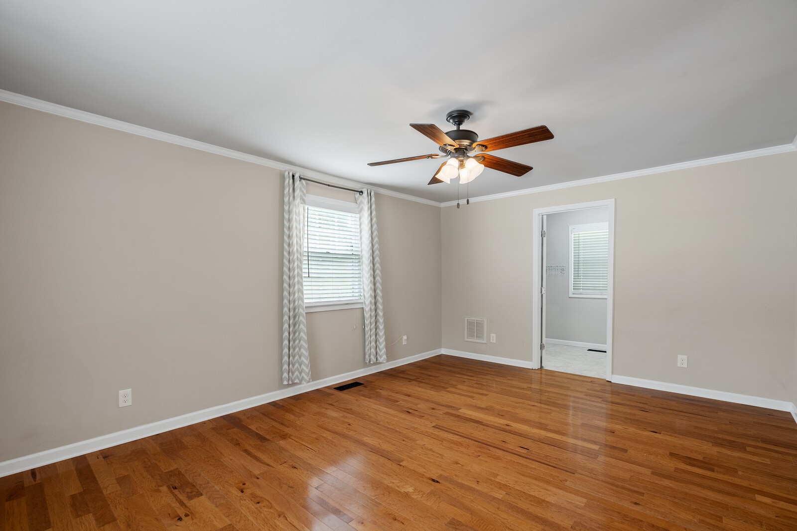 373 S Road Cottontown, TN 37048 - Photo 17 of 34 an empty room with wooden floor and ceiling fan