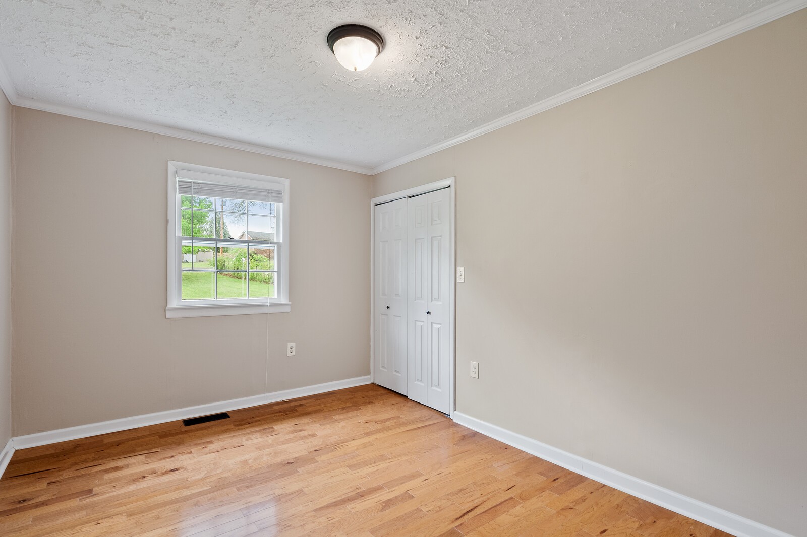 373 S Road Cottontown, TN 37048 - Photo 22 of 34 an empty room with wooden floor and windows
