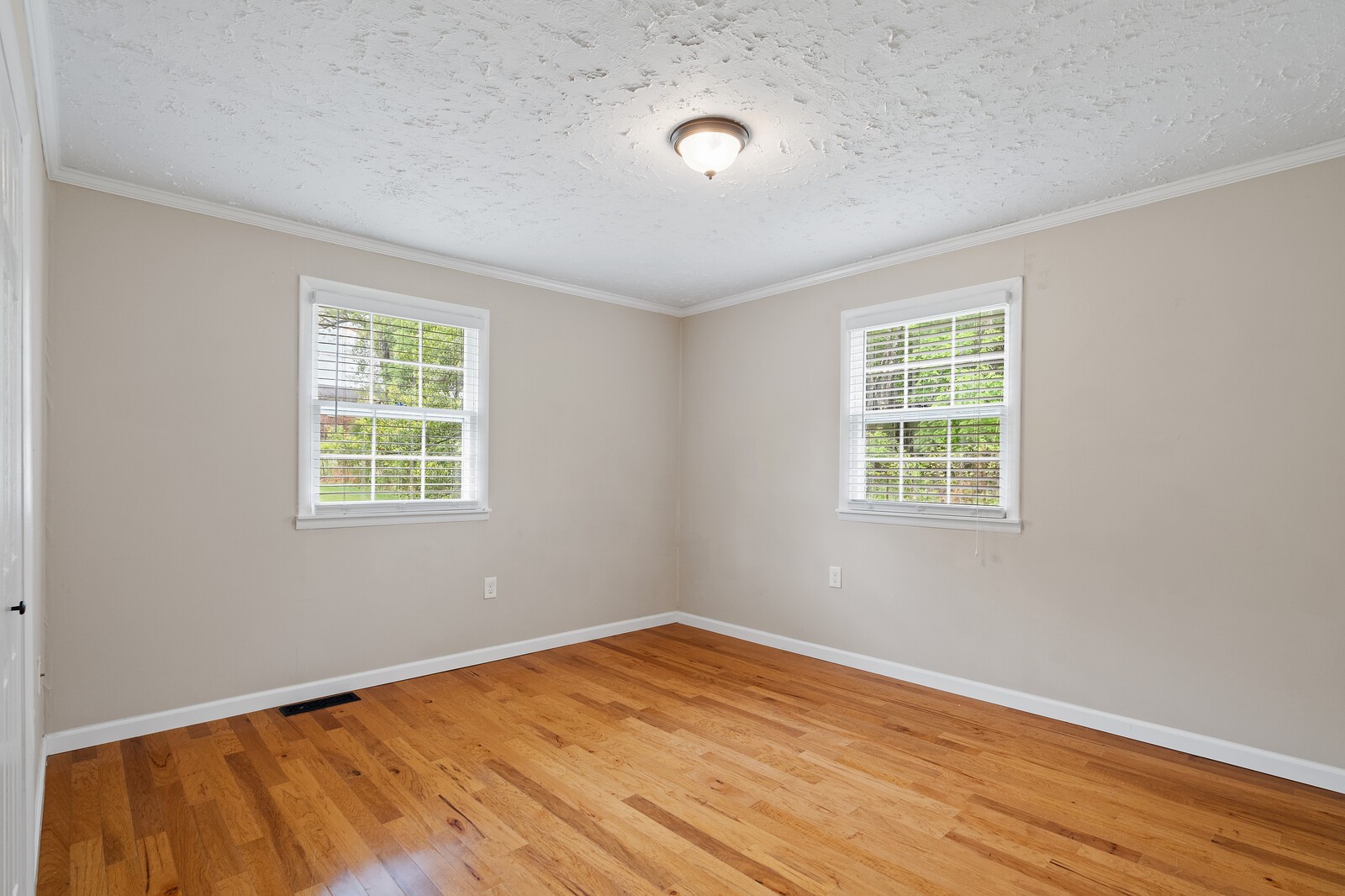 373 S Road Cottontown, TN 37048 - Photo 24 of 34 an empty room with wooden floor and windows