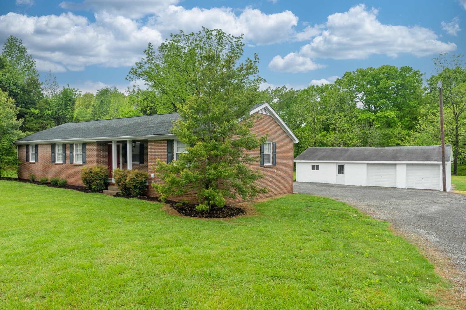 373 S Road Cottontown, TN 37048 - Photo 5 of 34 a front view of a house with a yard and garage