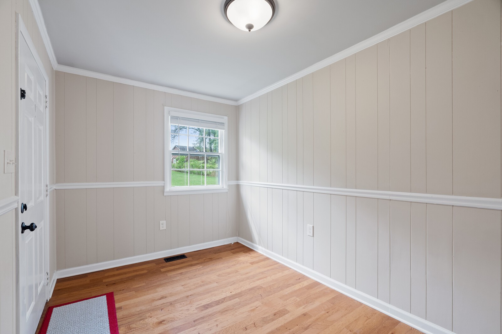 373 S Road Cottontown, TN 37048 - Photo 6 of 34 a view of an empty room with wooden floor and a window
