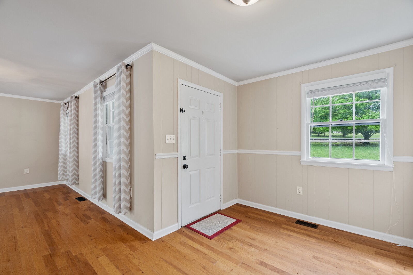 373 S Road Cottontown, TN 37048 - Photo 7 of 34 a view of an empty room with wooden floor and a window