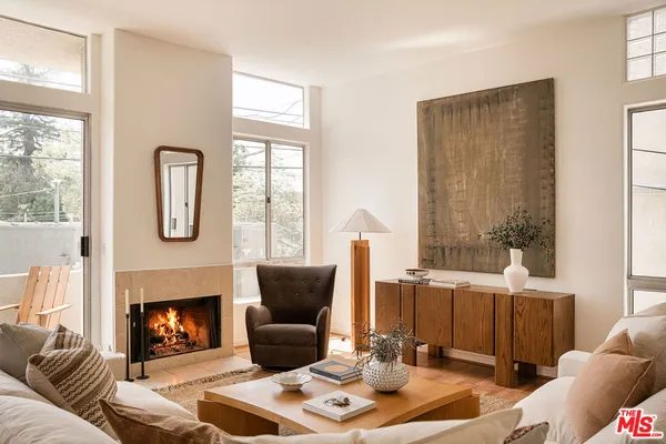 a living room with furniture a window and a fireplace