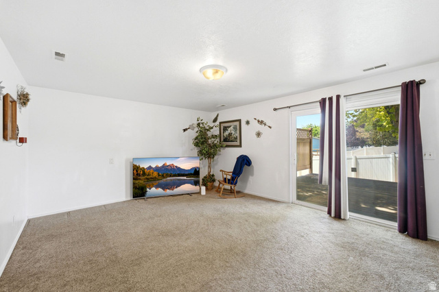 2475 Church Street Layton, UT 84040 - Photo 10 of 27 Carpeted interior space featuring white walls and a ceiling-mounted light fixture