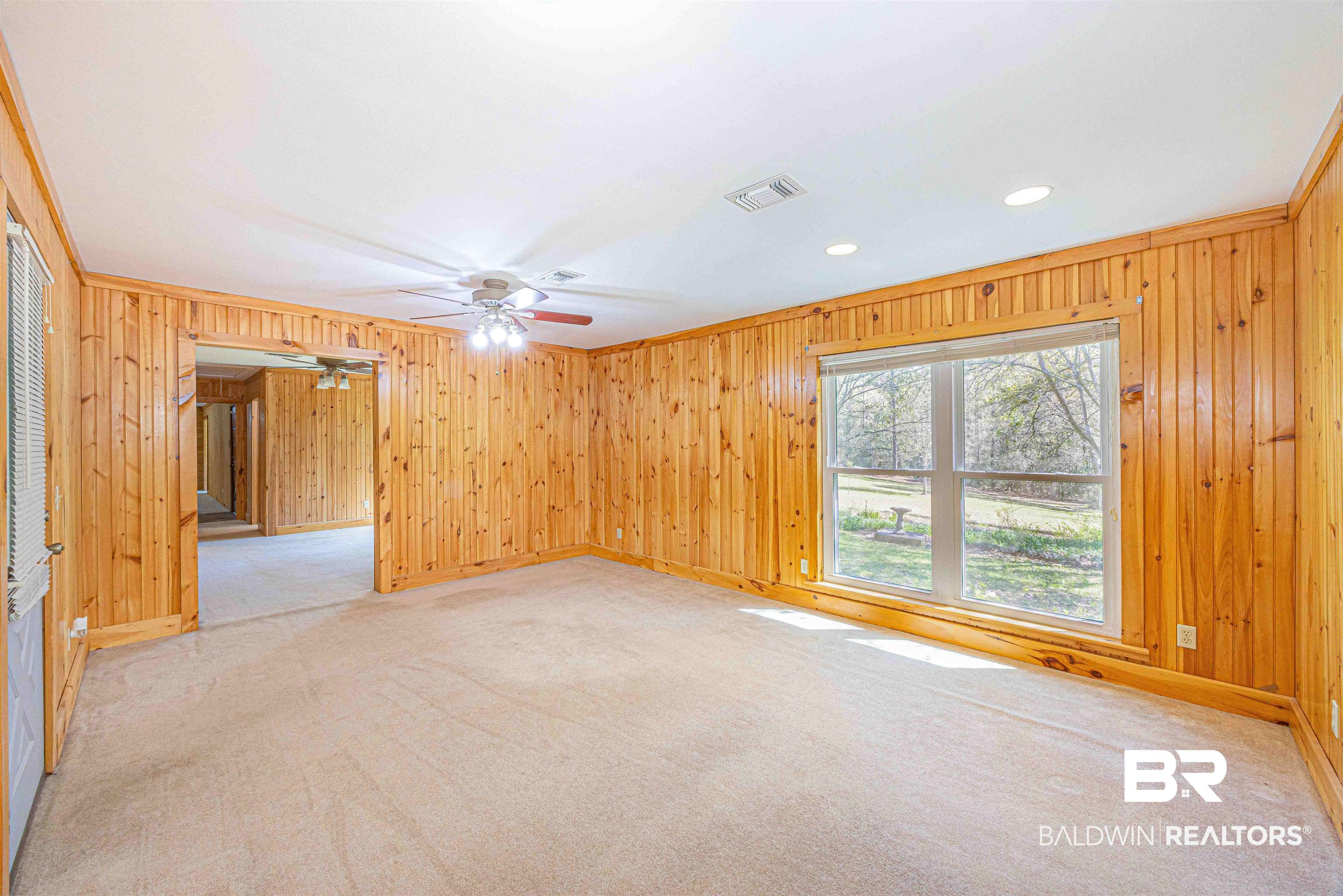 43101 Brown Road Bay Minette, AL 36507 - Photo 41 of 81 Unfurnished room featuring light colored carpet, wood walls, recessed lighting, and ornamental molding