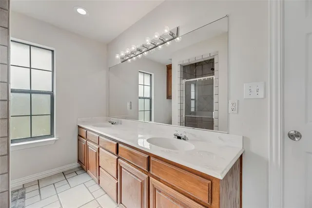 a bathroom with a sink double vanity and a tub
