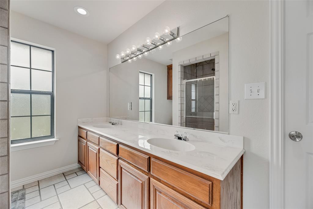 613 Torero Trail Oak Point, TX 75068 - Photo 11 of 32 a bathroom with a sink double vanity and a tub