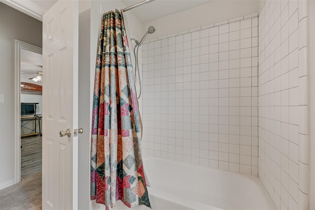 613 Torero Trail Oak Point, TX 75068 - Photo 16 of 32 a bathroom with a bathtub and a shower