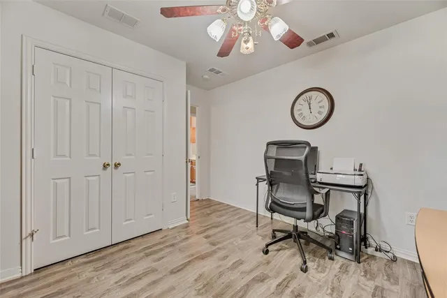a view of a workspace room with wooden floor