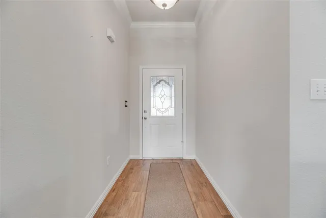 a view of a livingroom with wooden floor and a window