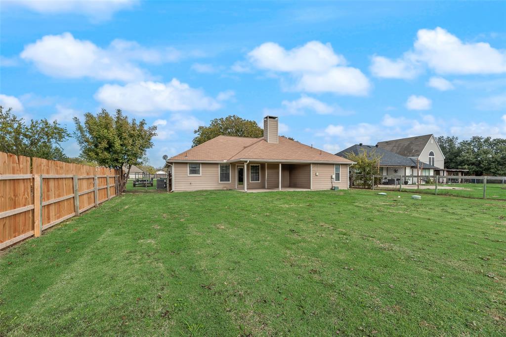 613 Torero Trail Oak Point, TX 75068 - Photo 21 of 32 a front view of a house with garden