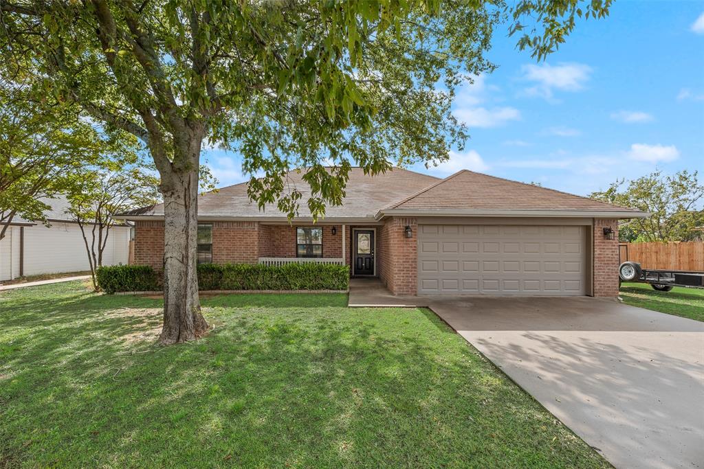 613 Torero Trail Oak Point, TX 75068 - Photo 23 of 32 a front view of a house with a yard and garage