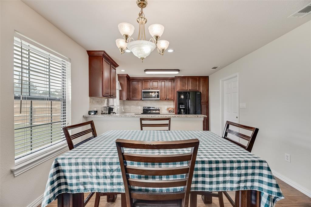 613 Torero Trail Oak Point, TX 75068 - Photo 28 of 32 a kitchen with a sink a stove a chandelier and a refrigerator