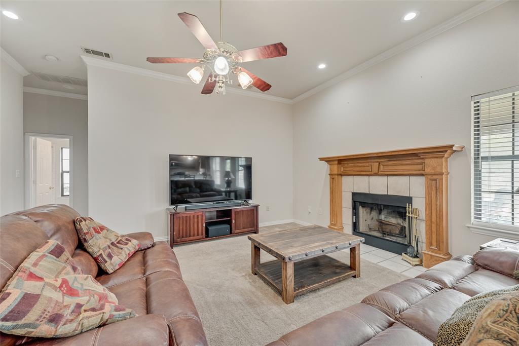 613 Torero Trail Oak Point, TX 75068 - Photo 29 of 32 a living room with furniture and a fireplace