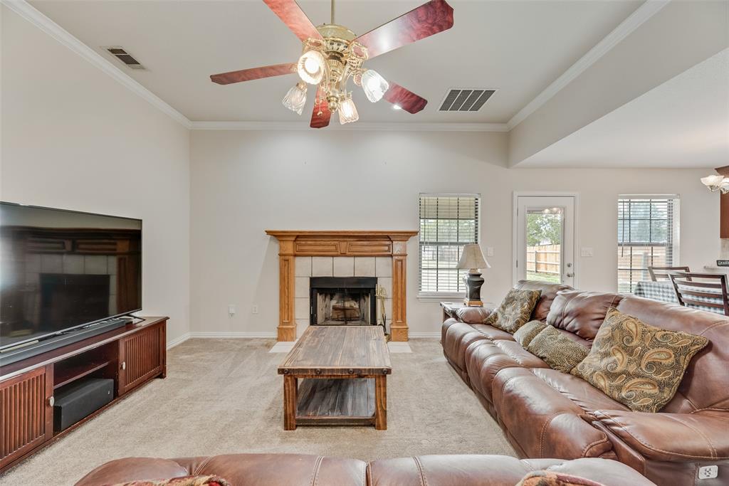 613 Torero Trail Oak Point, TX 75068 - Photo 8 of 32 a living room with furniture a flat screen tv and a fireplace