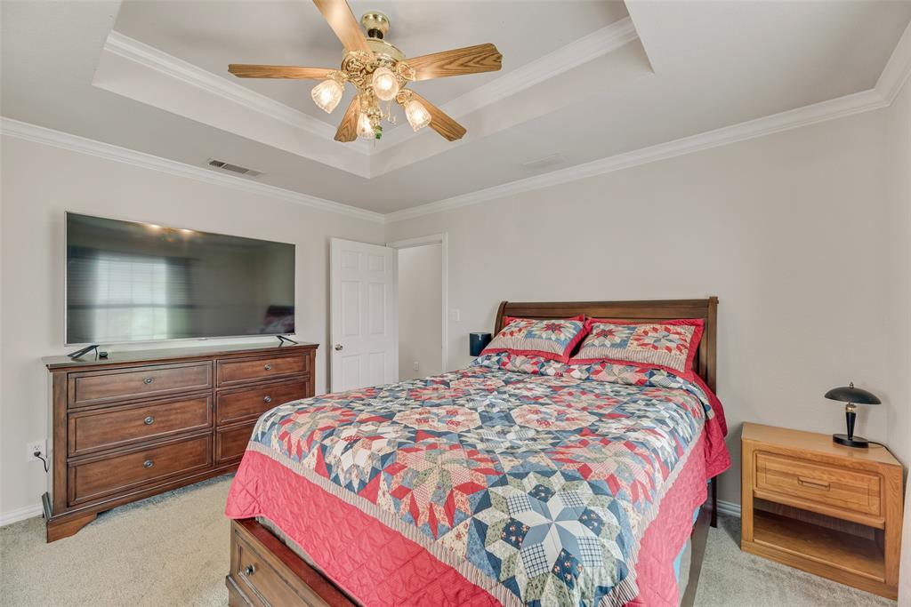 613 Torero Trail Oak Point, TX 75068 - Photo 10 of 32 a bedroom with a bed and a large mirror on the dresser