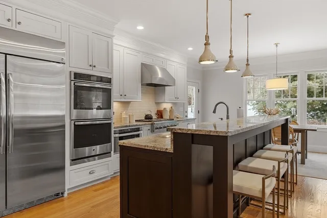 a kitchen with stainless steel appliances a sink a stove and a refrigerator