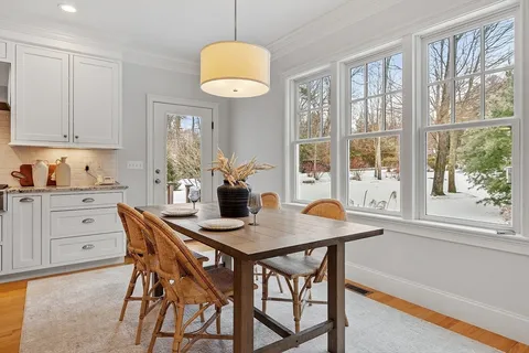 a view of room with hardwood and front door