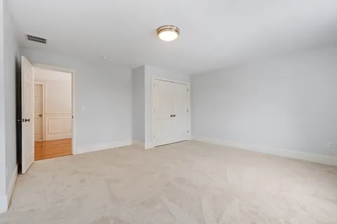 a bedroom with a bed and a chair