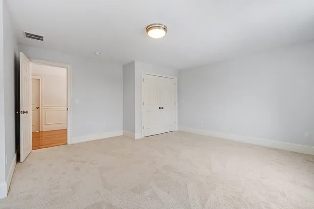 a bedroom with a bed and a chair