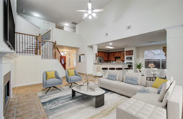 a living room with furniture and kitchen view