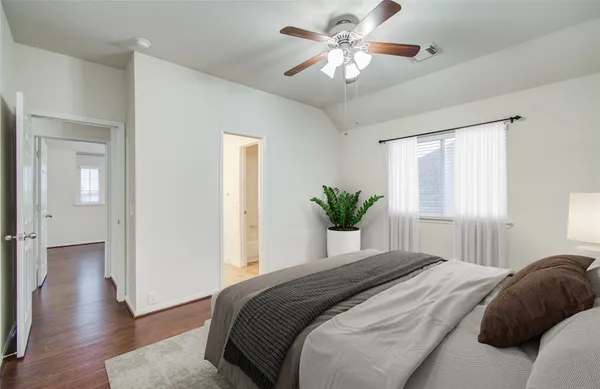 a bedroom with a large bed and a chandelier