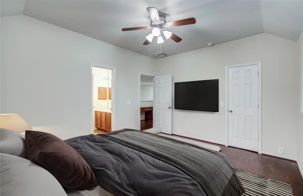 a bedroom with a bed and a flat screen tv
