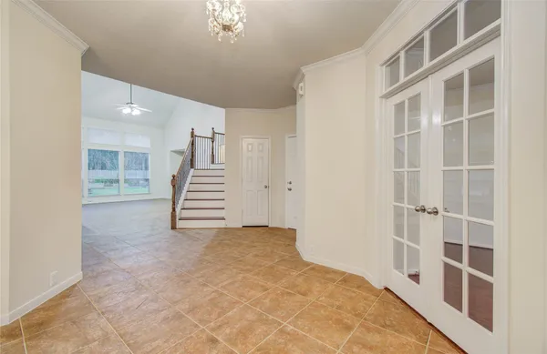 a view of an empty room with stairs and ventilation