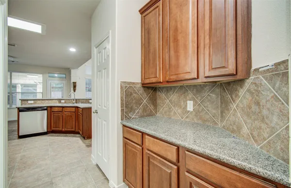 a view of a kitchen with a sink and cabinets