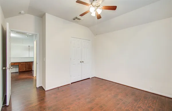 an empty room and chandelier fan
