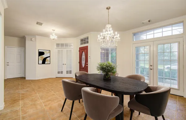 a view of a dining room with furniture and chandelier