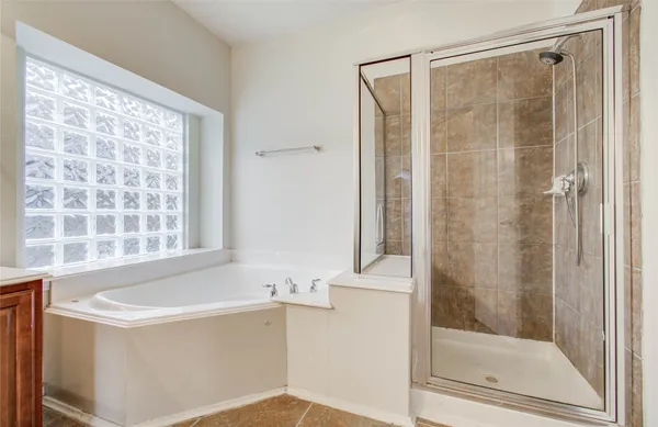 a bathroom with a shower and a bathtub