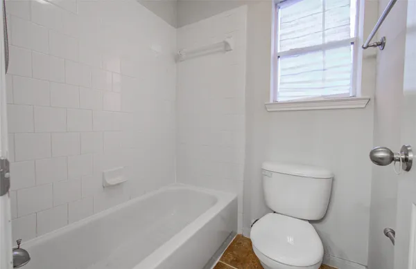 a bathroom with a toilet a sink and bathtub