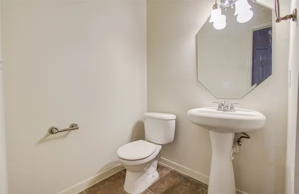 a bathroom with a sink a mirror and a toilet