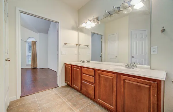 a spacious bathroom with a double vanity sink and a mirror
