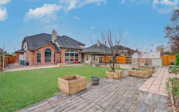 a front view of house with a garden and patio