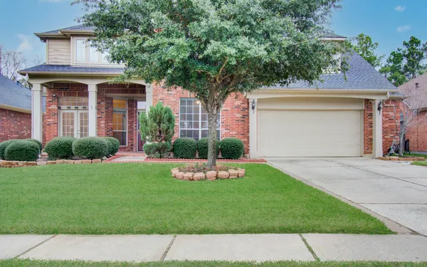 a front view of a house with a garden and plants