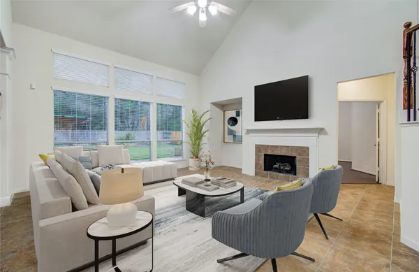 a living room with furniture a fireplace and a flat screen tv