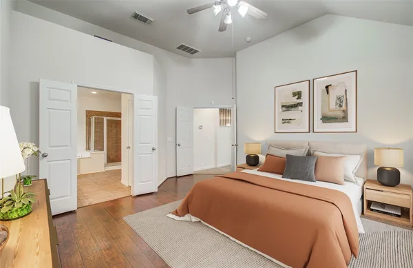 a bedroom with a bed and wooden floor