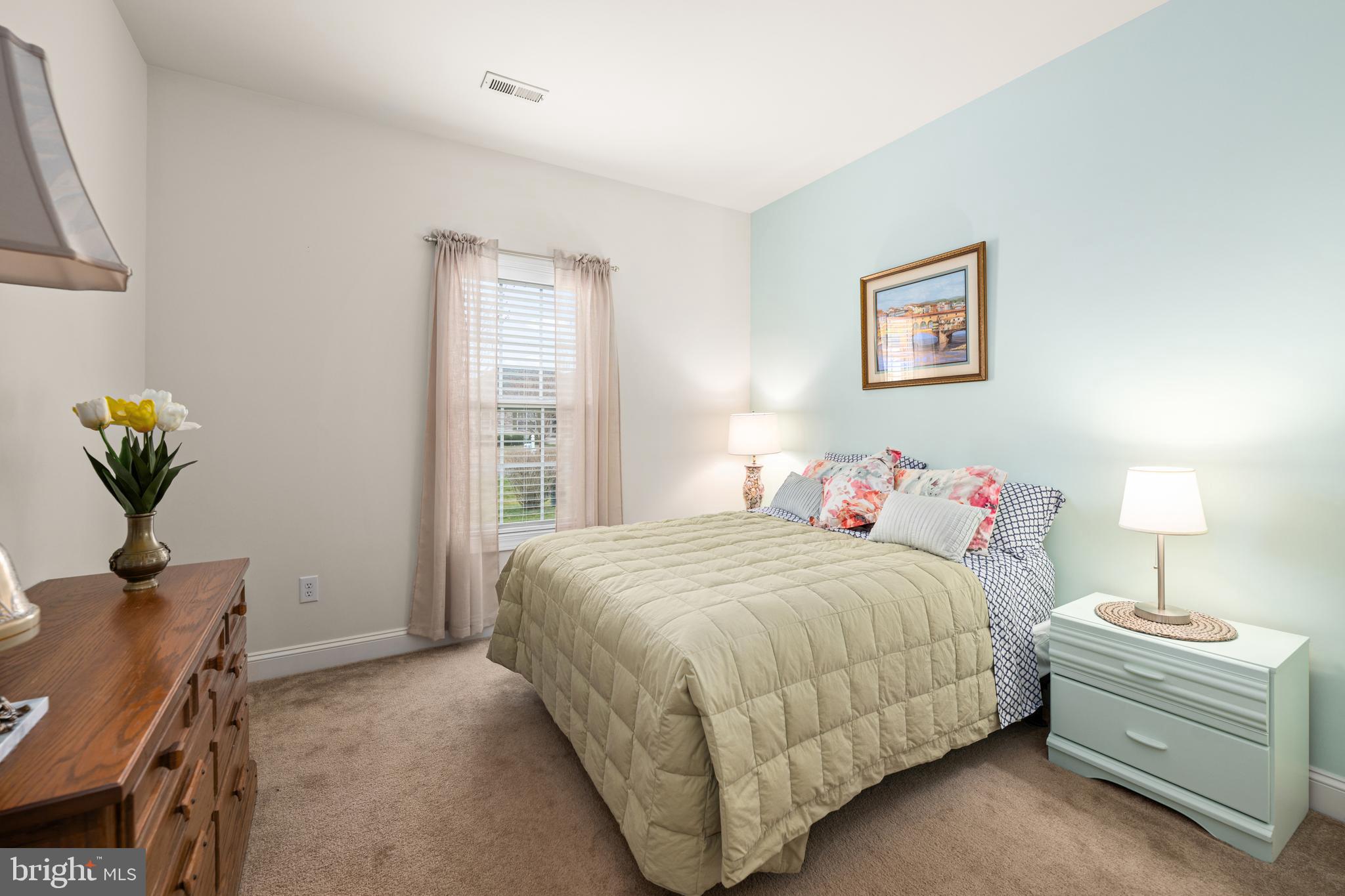 27400 Walking Run Milton, DE 19968 - Photo 12 of 35 a bedroom with a bed and a potted plant