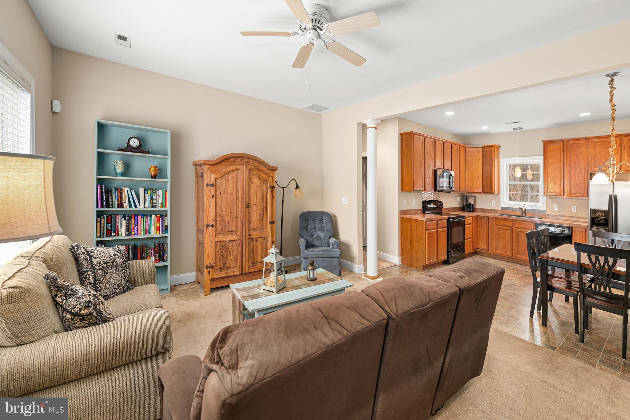 27400 Walking Run Milton, DE 19968 - Photo 3 of 35 a living room with furniture a rug appliances and a kitchen view