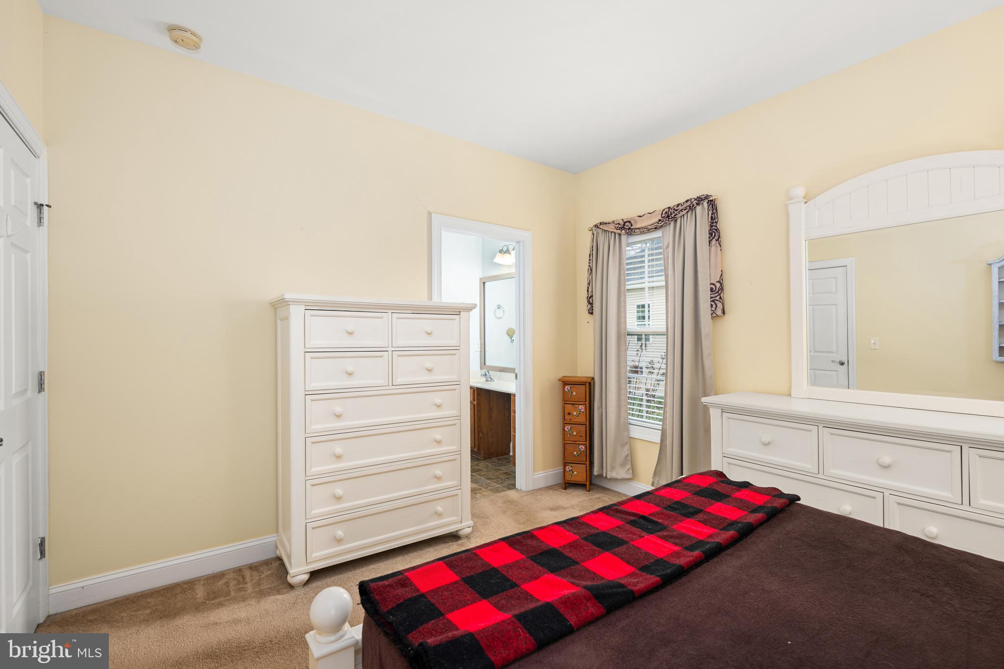 27400 Walking Run Milton, DE 19968 - Photo 9 of 35 a bedroom with a bed and dresser
