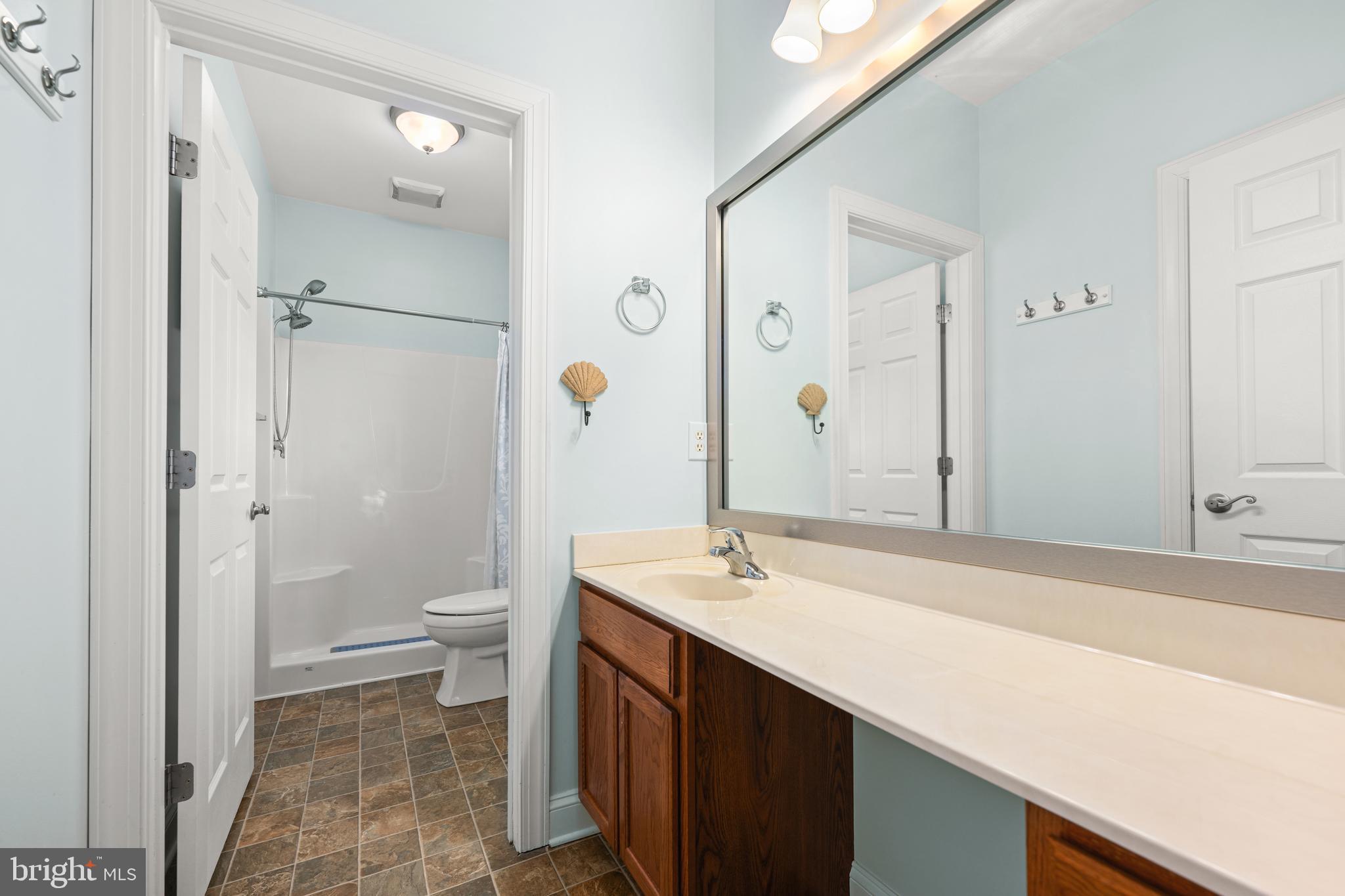 27400 Walking Run Milton, DE 19968 - Photo 10 of 35 a bathroom with a sink a toilet and shower