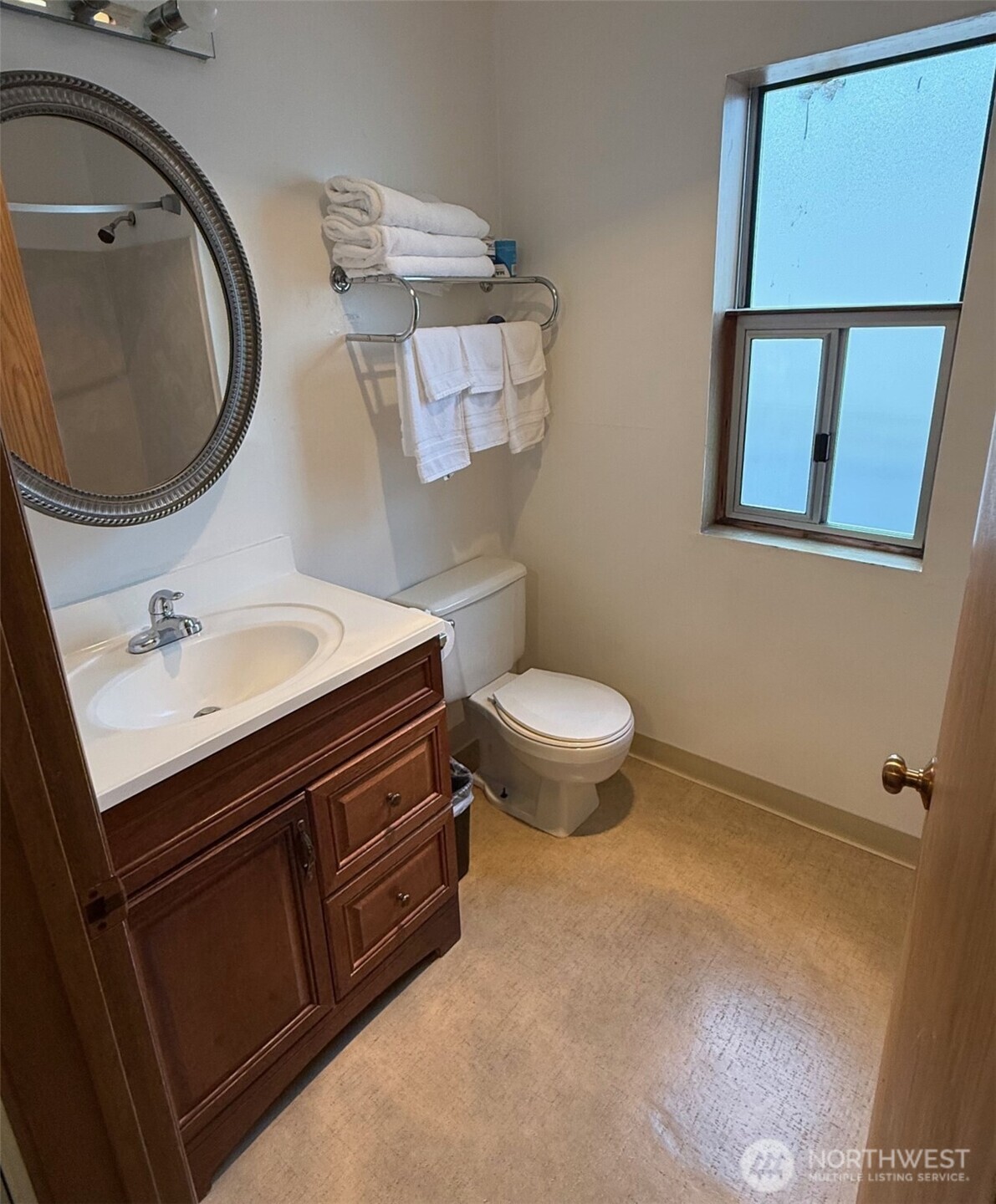 1120 North 91st Street Seattle, WA 98103 - Photo 15 of 23 a bathroom with a sink mirror vanity and toilet