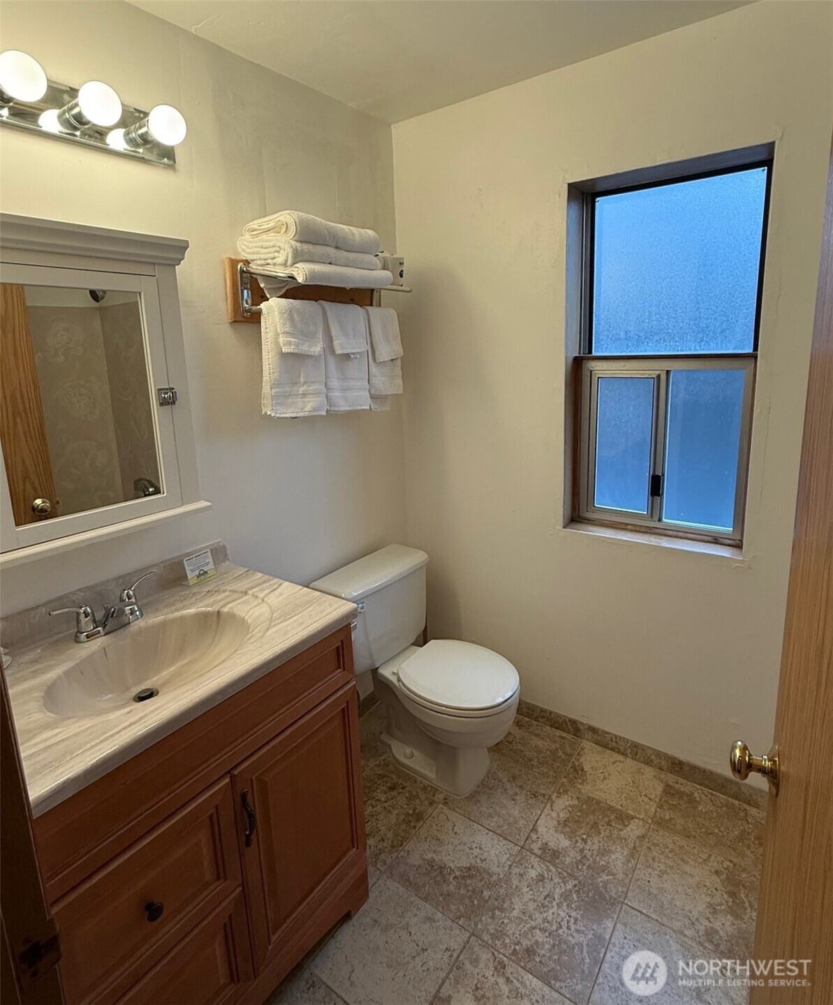 1120 North 91st Street Seattle, WA 98103 - Photo 16 of 23 a bathroom with a sink a toilet and mirror