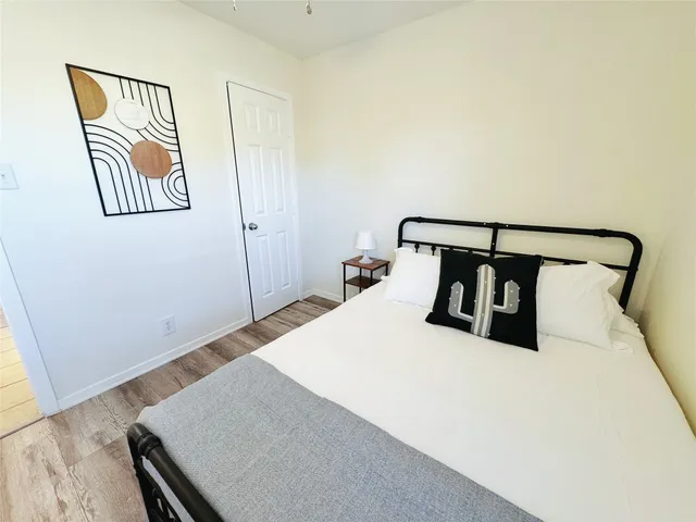 a bedroom with a bed and a night stand